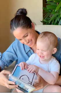 Meghan and Archie read a book